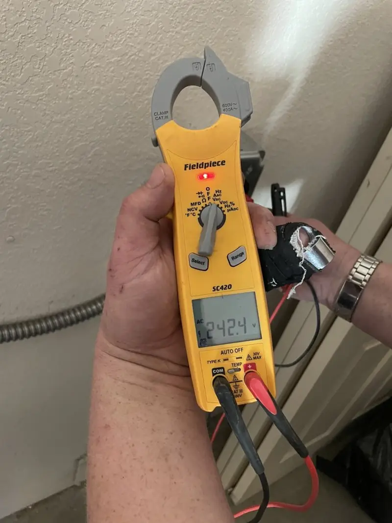 Voltage testing with clamp meter during Outlet Installation in Doolittle